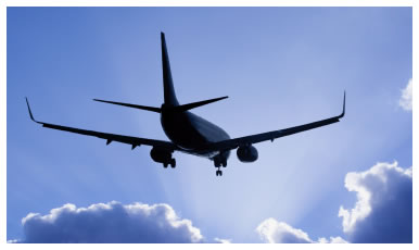 Aircraft silhouetted aginst a cloudy sky